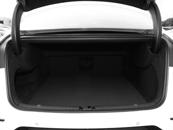 Pictures of the trunk of a white BYD Han, showing that it is roomy and has plenty of capacity.