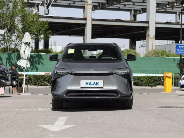 A close-up view of the front end of a gray Toyota BZ4X electric car, where you can clearly see the license plate with the HiLuck logo hanging between the two headlights on the head.