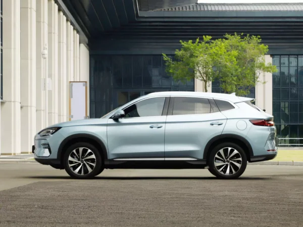 Close-up image of the side of a silver BYD Song Plus electric car with the vehicle parked on a concrete pavement.