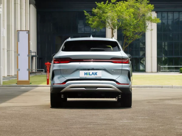 A detailed picture of the rear of a BYD Song Plus electric car with prominent red lights on both sides.