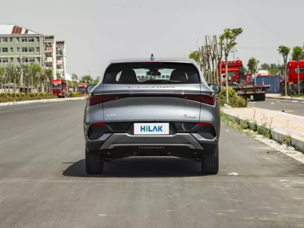 Detailed view of the rear of a silver-gray BYD Yuan Plus electric car parked on the side of an asphalt road.