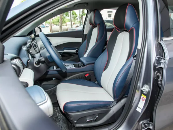 Close-up view of the specific details of the BYD Yuan Plus electric car vehicle with the front door of the driver's compartment open to look in.