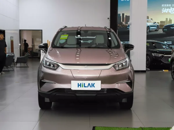 A close-up view of the front of a pink BYD Yuan Pro electric car, with the vehicle parked in a showroom.