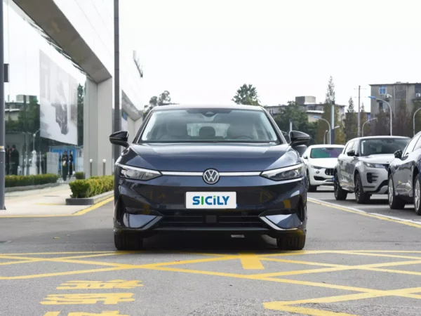 A picture of the front angle of a dark blue Volkswagen ID.7 Vizzion in front of a car store.