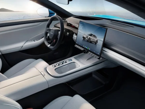 Picture of the driver's seat of the Xiaomi SU7 electric car with a screen in the center and the vehicle's interior in black and white.