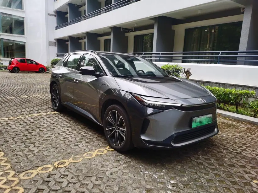 A silver Toyota BZ4X electric car parked in a parking space