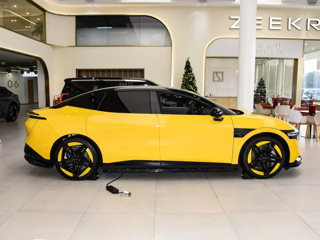 The side of a yellow Zeekr 007 parked in the showroom