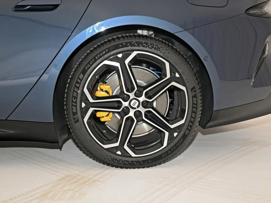 A Michelin tire of a dark-blue Xiaomi SU7 electric car