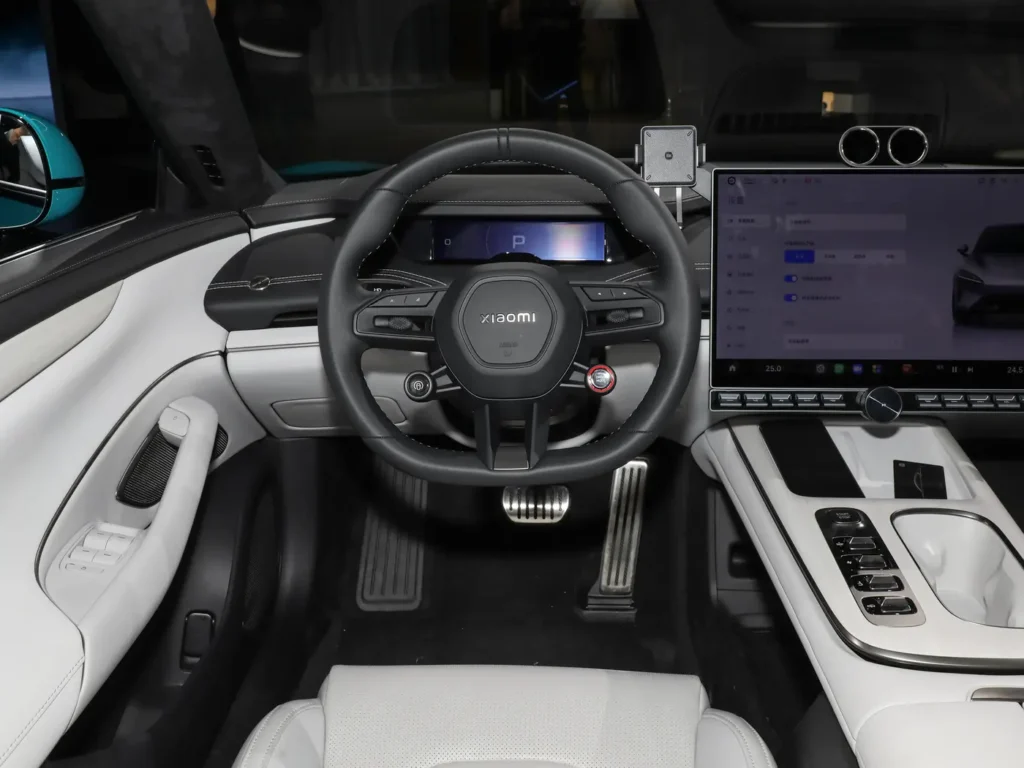 A black leather-wrapped steering wheel in a white interior Xiaomi SU7 electric car