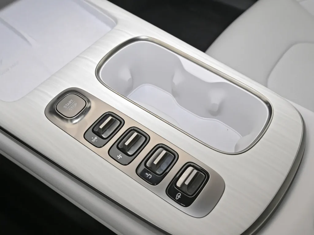 A center console for cups and a starter button and some toggles of Xiaomi SU7 electric car